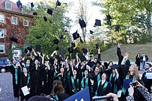 The new graduates of the Europa-Institut in Germany gather to throw their mortar boards in the air as part of a graduation ceremony. Europa-Institut graduation.jpg