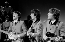 Paul McCartney, George Harrison and John Lennon of the Beatles performing on Dutch TV in 1964