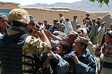Members of the Romanian Army sharing gifts with children in Afghanistan, 2009 Sharing Gifts (4497043378).jpg