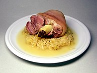 Pickled eisbein (pickled ham hock), served with sauerkraut. In parts of Germany it is known as schweinshaxe.