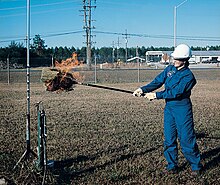A NASA engineer sweeps an area with a corn broom to find the location of a hydrogen fire. Hydrogen burns with a nearly-invisible flame. Hydrogen Flame Broom Test NASA.jpg
