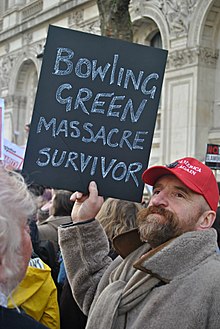 Man holding sign that reads 