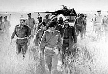 King Hussein on 21 March 1968 checking an abandoned Israeli tank in the aftermath of the Battle of Karameh. Karama aftermath 1.jpg