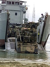 M-113 armoured personnel carriers disembarking on a beach from a Balikpapan-class landing craft M-113 LCH (USMC).jpg