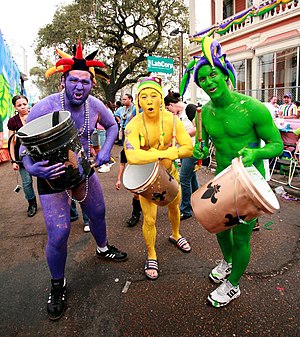 New Orleans Mardi Gras. Three revelers painted...