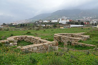 View across a ruined bath complex showing the basins and water features