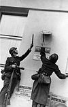 Wehrmacht soldiers destroying Polish government insignia
