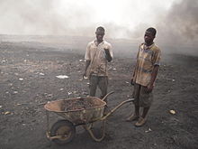 Agbogbloshie e-waste workers completing a burn for copper recovery, 2010 E-waste workers.jpg