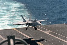 An F/A-18A Hornet lands on Enterprise in 1987. F-18A VFA-161 landing on USS Enterprise (CVN-65) 1987.JPEG