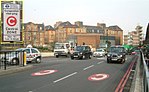 At Old Street, street markings and a sign (inset) with the white-on-red C alert drivers to the charge. The sign displays the original operating hours for the scheme.