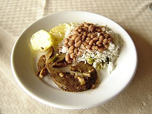 Rice, beans, meat and potatoes, as served in a...