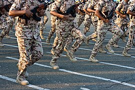 Saudi Arabia National Guardsmen run past in three-colour desert DPM.