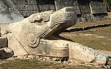 Plumed Serpent Serpent head at the base of El Castillo.jpg