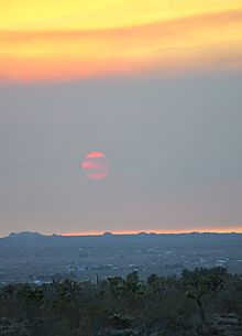 Haze as smoke pollution over the Mojave from fires in the Inland Empire, June 2016, demonstrates the loss of contrast to the Sun, and the landscape in general. Spooky Summer Sunset.jpg