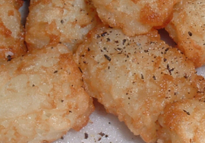 A close-up of a plate of Tater Tots.