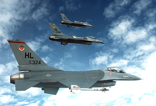 An air-to-air right side view of a three-ship echelon formation of F-16 Fighting Falcon aircraft DF-ST-83-07625