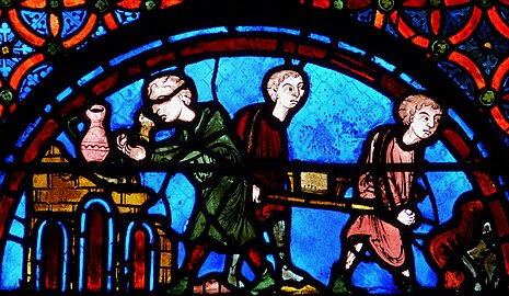 Porters carrying stone depicted in window of Bourges Cathedral