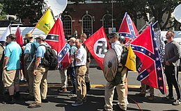 Alt-right members preparing to enter Emancipation Park holding Nazi, Confederate, and Gadsden "Don't Tread on Me" flags.