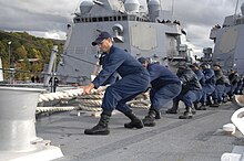 U.S. Navy sailors hauling in a mooring line Defense.gov News Photo 100930-N-2855B-251 - U.S. Navy sailors aboard the guided missile destroyer USS Bainbridge DDG 96 haul in a mooring line while mooring the ship in Faslane Scotland on.jpg