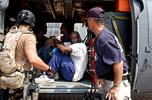 A DMAT member assures a rescued man that the trip to the airport will be safe. FEMA - 14850 - Photograph by Win Henderson taken on 09-05-2005 in Louisiana.jpg