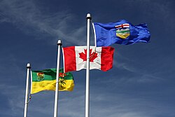 The flags of Saskatchewan and Alberta flanking the flag of Canada in Lloydminster