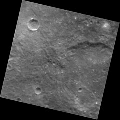 Part of Guido d'Arezzo crater at right. The small crater in upper left may have hollows on the rim. Guido d'Arezzo crater EN1035298482M.jpg