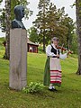 Geigenspielerin neben der Büste von Karl Trotzig anlässlich der 100-Jahr-Feier.