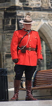 A constable of the Royal Canadian Mounted Police in full dress. Constables are typically the lowest rank in Canadian police services. Mountie-on-Parliament-Hill.jpg