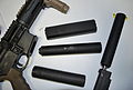 Assorted firearms suppressors.