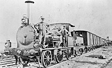 Crew stood with a railway engine (1873) Victorian Railways F Class.jpg