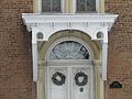 Main entry trimmed in arched stone half-rounds.