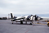 A Marine VMA-231 AV-8A with a camouflage paint during pre-flight operations. Harrier has two napalm bombs on its right wing. DN-ST-83-05846.JPEG