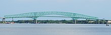 The Hart Bridge is a continuous, cantilevered truss bridge with an unusual design that includes a suspended road deck on the 332-metre (1,088 ft) main span and a through truss deck on the adjacent approach spans. HartBridgeJax.jpg