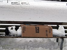 A street bench in Kitsilano, British Columbia, Canada, with a snowman depicting a homeless person Homeless snowman (3147026895).jpg