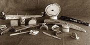 Various turn-of-the-century Inuit carvings, including cribbage boards and knives. Photo circa 1900