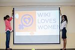 Two members of WUGN lifting the logo of Wiki Loves Women to signify their support for the project