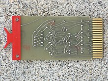 A board designed in 1967; the sweeping curves in the traces are evidence of freehand design using adhesive tape S111FlipChipBack.jpg