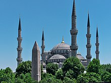 Sultan Ahmed Mosque is known as the Blue Mosque due to the blue Iznik tiles which adorn its interior. The Obelisk of Thutmose III (Obelisk of Theodosius) is seen in the foreground. Sultanahmet Camii, Istanbul.jpg