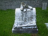 Gravestone with marble shoes and stockings