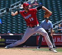 A baseball player in red and gray