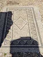 A mosaic with a wave pattern border