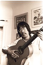 Frank Chin plays the guitar in his San Francisco apartment in 19.jpg