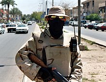 An armed Iraqi interpreter on patrol with U.S. troops on the streets of Baghdad. They became frequent targets of insurgents during the war. IraqiInterpreter.jpg