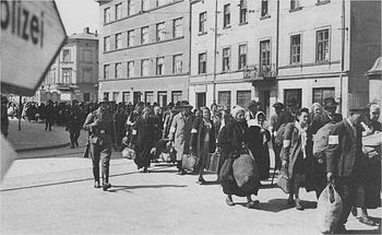 SS guards overseeing Jews being rounded up in March 1943 during the liquidation of the Krakow Ghetto.