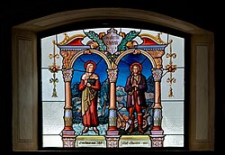 Házaspárok mintája a Mária mennybemenetele plébániatemplom ólomüveg ablakán. Az ablak két szentet ábrázol, Torribia Máriát és Izidor Gazdát, akik házasok voltak (Nesselwängle, Ausztria)