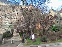 Vue d'une muraille à partir d'une rue en contrebas et de maisons anciennes