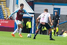 Dwight McNeil looks to take a Montpellier player on in pre-season for Burnley