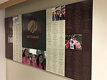 Long, rectangular engraved Corian display for the Girl Scouts of the Gulf Coast with photos of troop members participating in activities.