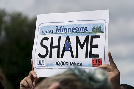 Minnesota Shame sign held at a rally