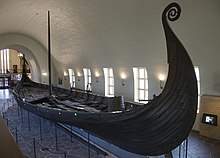 The Oseberg ship contained the bodies of two women and was buried beneath an earthen mound. Osebergskipet 2016.jpg